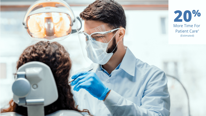 Masked male dentist wearing blue surgical gloves cleaning a female patients teeth