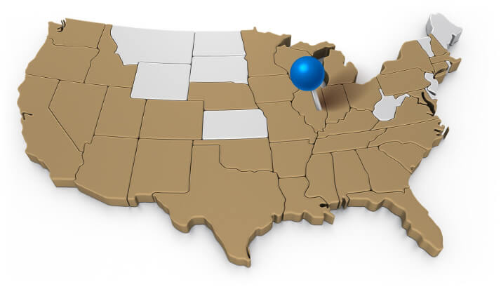 Map of the United States with most states colored brown, a few others are grey. A blue map pin sticks in Illinois.