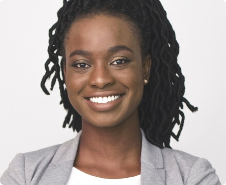 Smiling young black woman wearing a grey blazer
