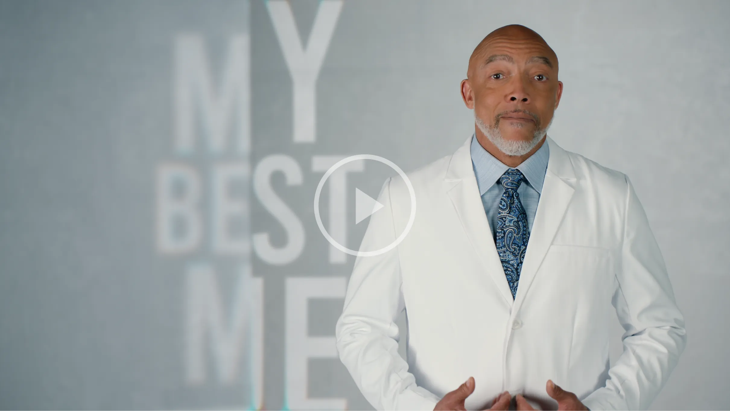 my best me video poster male doctor in white medical coat blue shirt and paisley tie