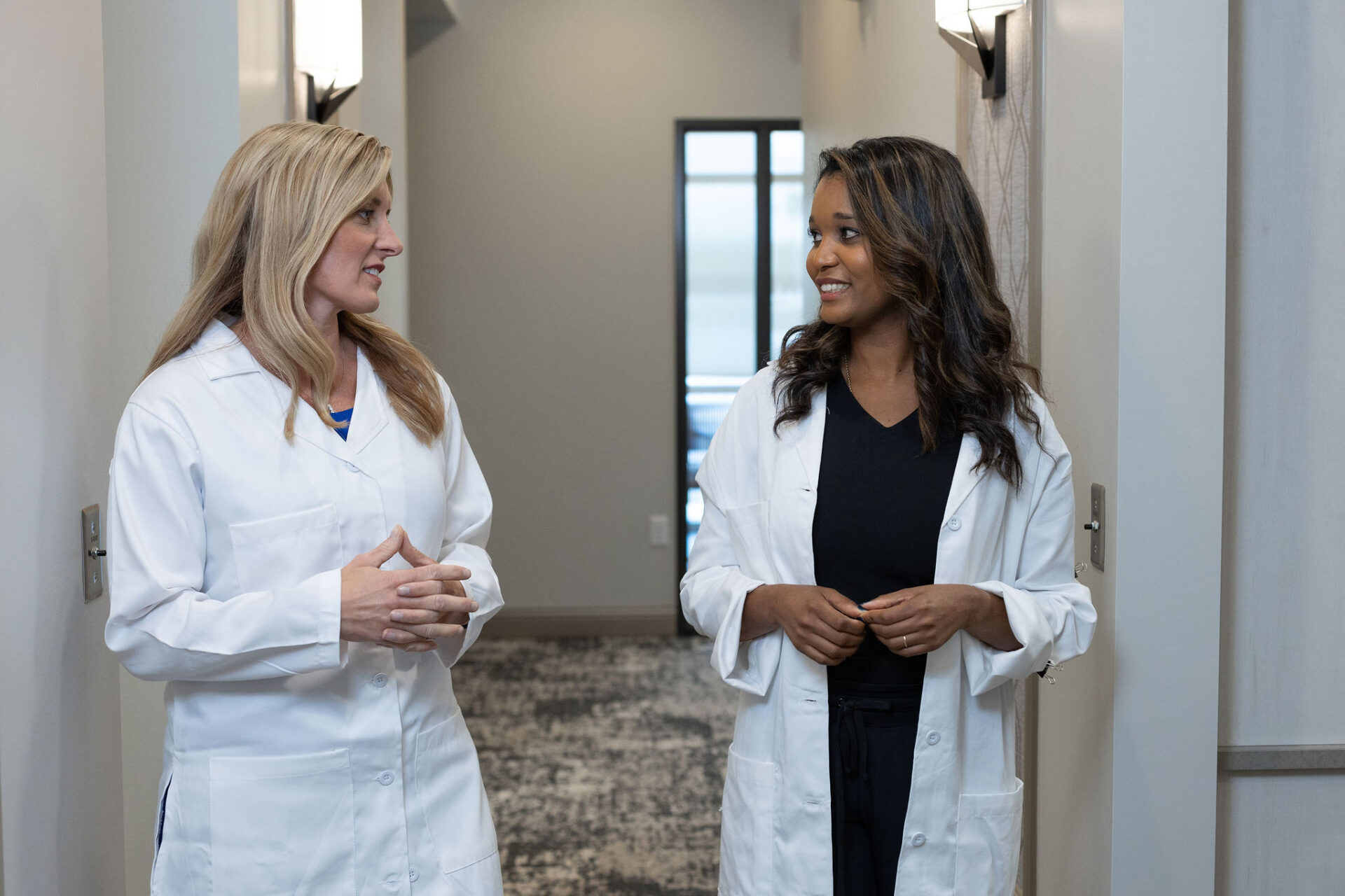 Two women in white coats