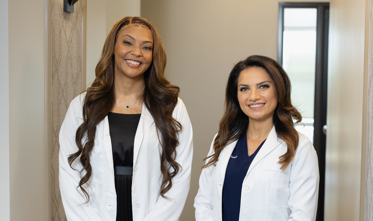 Two women in white lab coats