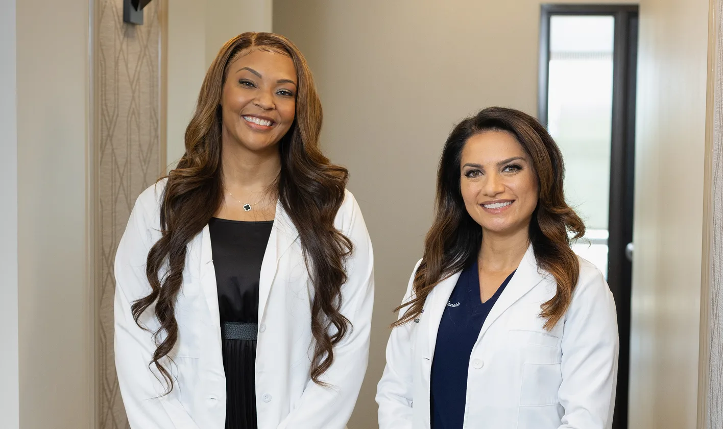 Two women in white lab coats