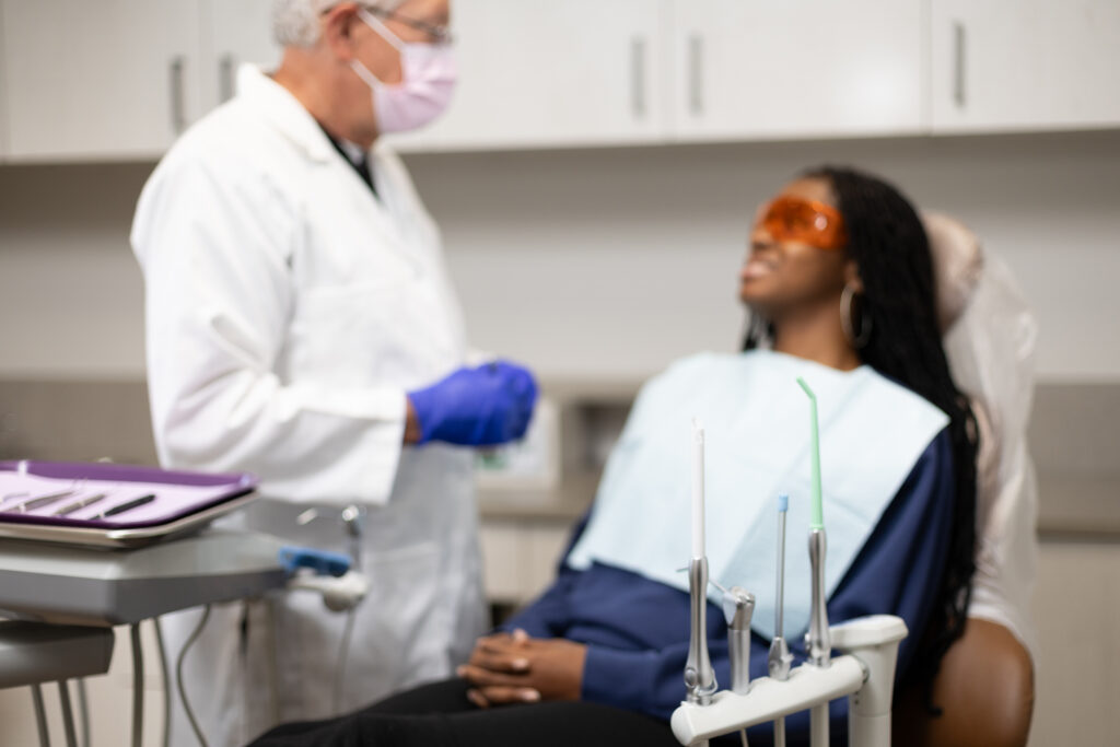 dentist with patient with tools