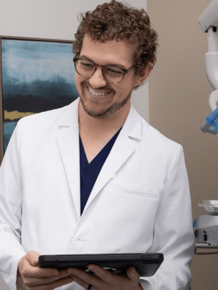 heartland dentist in exam room with chart